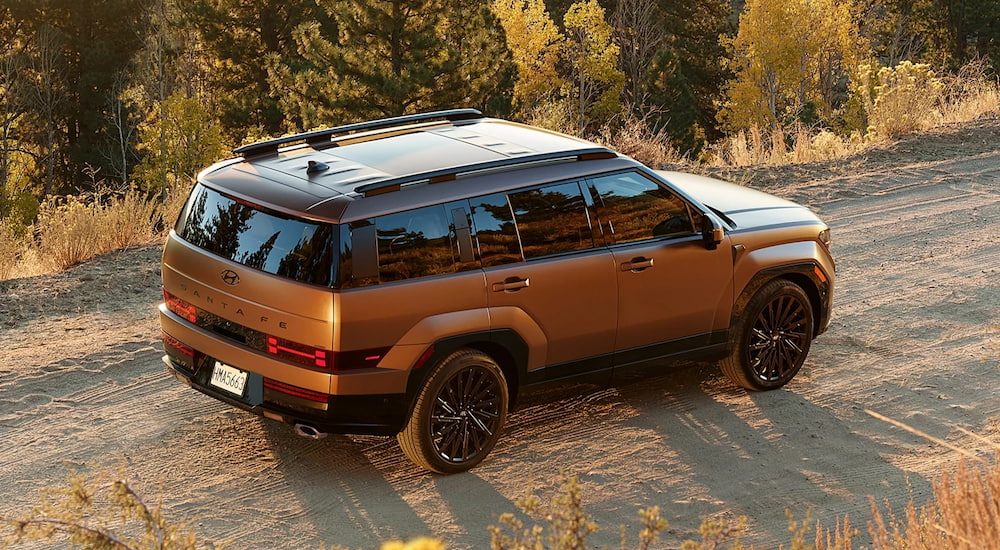 Overhead view of a bronze 2024 Hyundai Santa Fe parked on a dirt road.