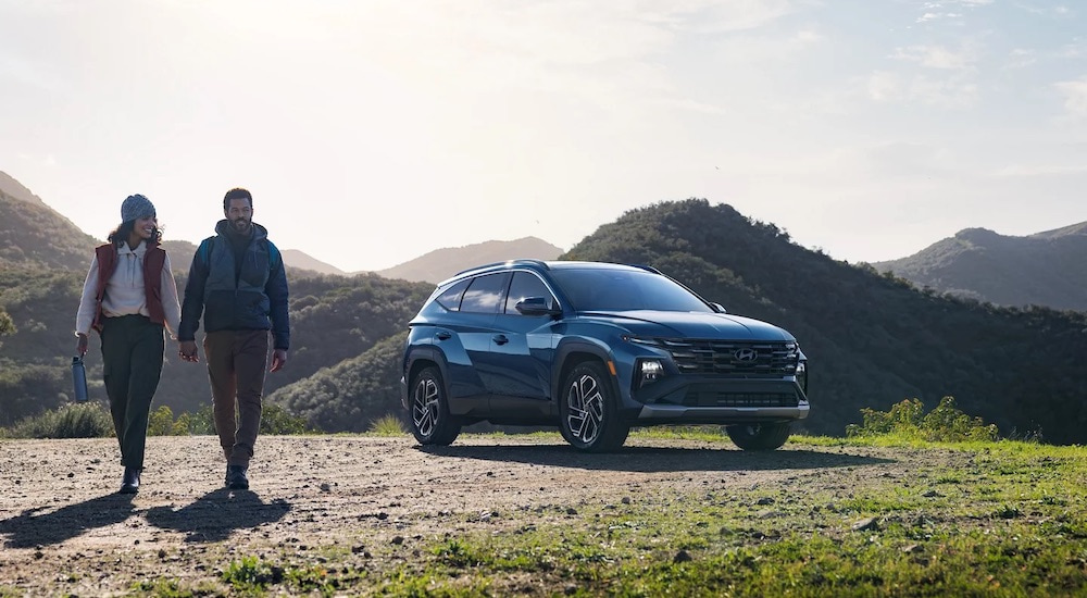 A blue 2024 Hyundai Tucson Limited is shown from the front at an angle.