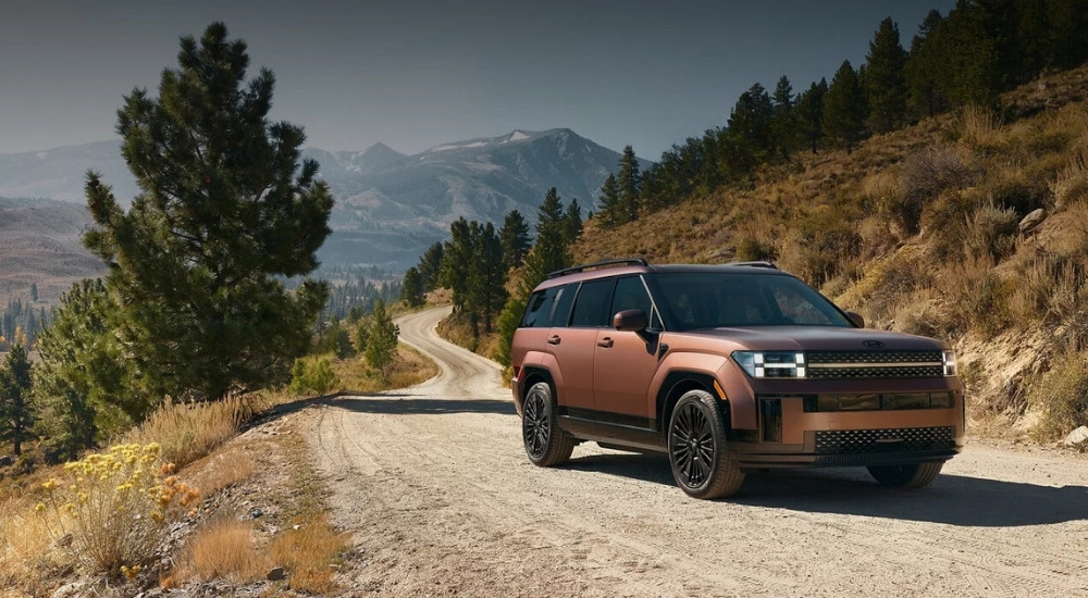 A bronze 2025 Hyundai Santa Fe for sale is shown from the front an angle.