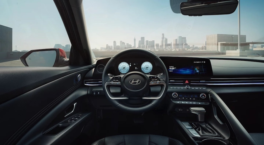 The black interior of a 2025 Hyundai Elantra for sale is shown from the drivers seat.
