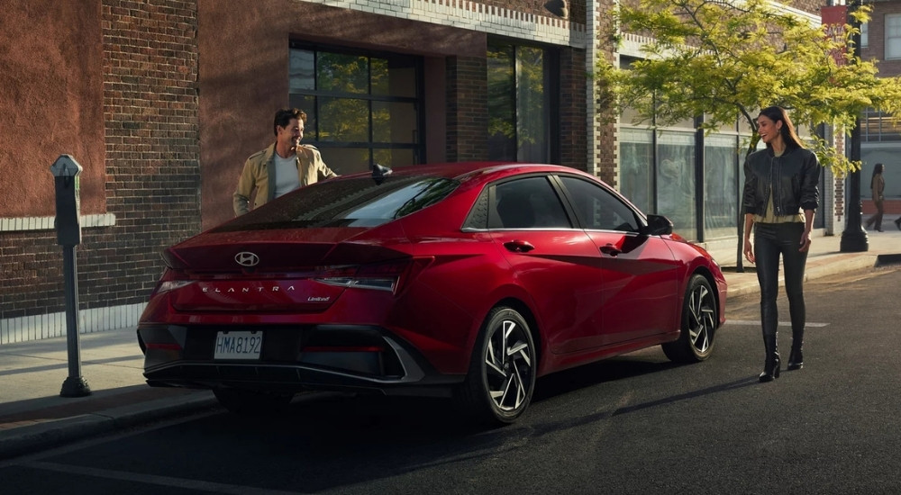 A red 2025 Hyundai Elantra is shown from the rear at an angle.