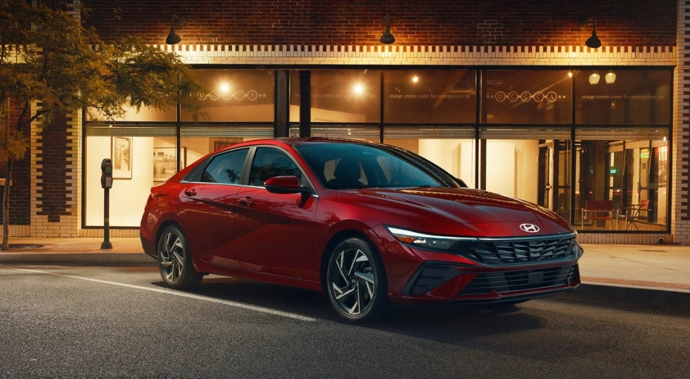 A red 2025 Hyundai Elantra for sale is shown from the front at an angle.