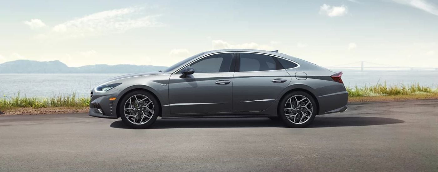 A grey 2022 Hyundai Sonata N-Line is shown from the side overlooking a bay.