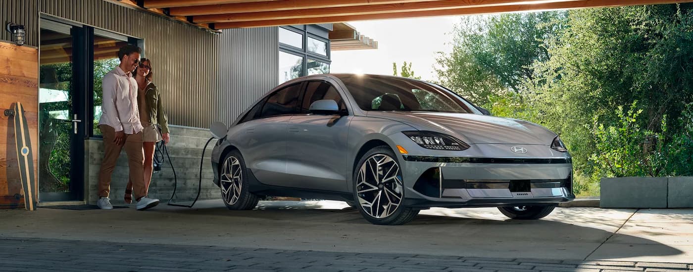 A grey 2024 Hyundai IONIQ 6 is shown from the front at an angle while charging.