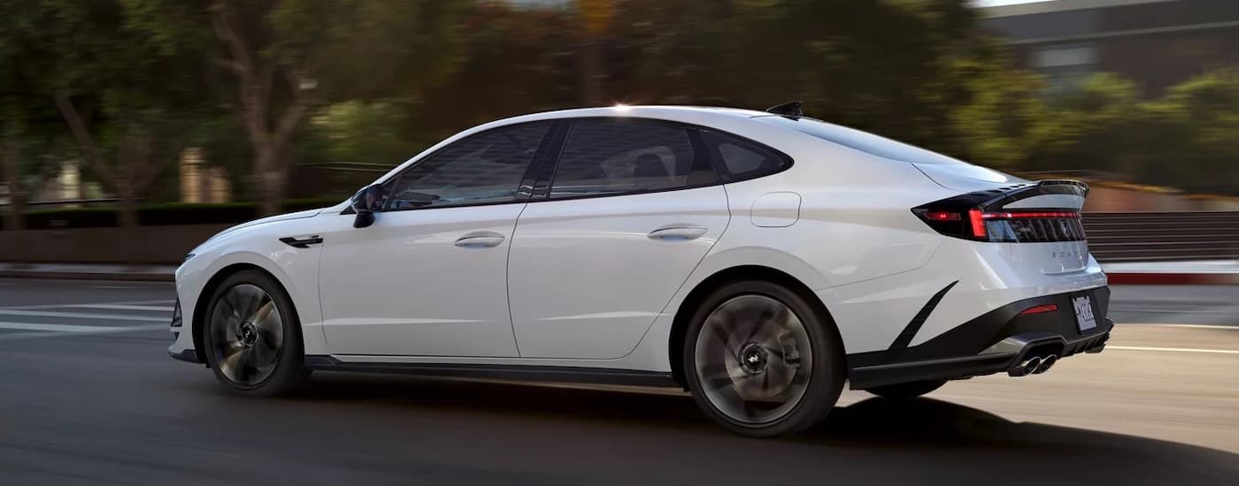 A white 2024 Hyundai Sonata N-Line is shown from the side after leaving a Hyundai dealer.